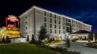 Boomtown New Orleans Hotel with riverboat casino in background
