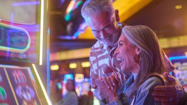 couple sitting at slot machine